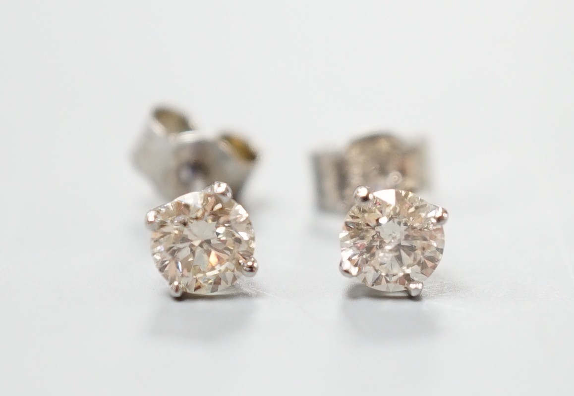 A pair of white metal and solitaire diamond set ear studs, gross weight 0.8 grams, stone diameter approx. 3.5mm.